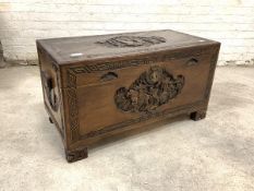 A Chinese style camphor wood chest, late 20th century, the lid and body typically carved with