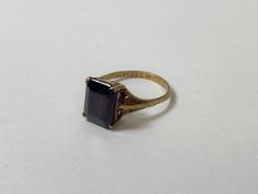 A single dark red stone ring, marked 9ct, size O
