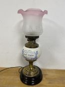 An Edwardian oil lamp converted to electric, with shade, the ceramic reservoir inscribed Mortar