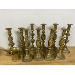 A group of ten brass candlesticks, some inscribed The Queen of Diamonds, others The Diamond