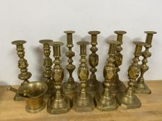 A group of ten brass candlesticks, some inscribed The Queen of Diamonds, others The Diamond