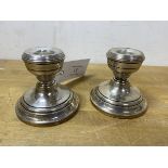 A pair of 1919 Birmingham silver weighted candlesticks, each measures 7cm high