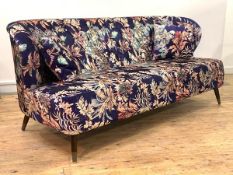 A striking mid century modern style sofa, upholstered in a navy blue ground buttoned velvet with