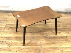 A vintage mid century low table, the teak veneered top raised on tapering ebonised supports,