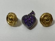 A white metal heart shaped locket with diamonds and amethysts to front and pierced to rear, measures