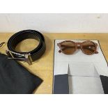 A pair of sunglasses by Finlay & Co, having wooden frames, measures 14cm across, a Dunhill black