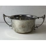A 1935 Birmingham silver porringer, the twin handles with acorn finial's, initials to front and