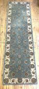 A Persian Tabriz style machined runner rug, the blue ground with arabesques and flower heads