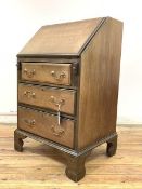 An Edwardian mahogany bureau, of small proportions, the fall front enclosing fitted interior,