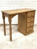A pine single pedestal desk, the rectangular moulded top over four drawers and turned supports,