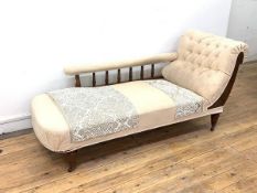 A Late Victorian walnut framed chaise longue, upholstered in ivory floral damask, the arm rest