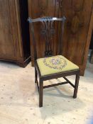 An 19thc side chair the top rail with scrolled corners over intricately pierced splat over drop in