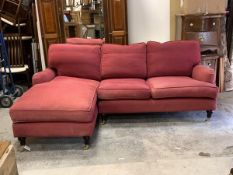 A Howard and sons style corner sofa and chaise, with squab cushions, upholstered in a faded claret