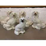 A collection of Staffordshire spaniels, largest measures 32cm high