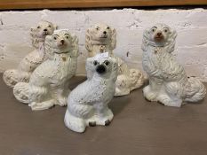 A collection of Staffordshire spaniels, largest measures 32cm high