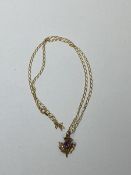 A thistle pendant necklace, chain and pendant both marked 9ct, pendant with amethyst, measures 26cm,
