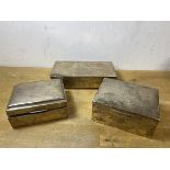 A group of three early 20thc hallmarked silver cigarette boxes, tallest measures 5.5 cm x 11.5cm x