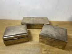 A group of three early 20thc hallmarked silver cigarette boxes, tallest measures 5.5 cm x 11.5cm x