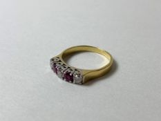 A diamond and ruby ring marked 18ct, size M, weighs 3.03 grammes