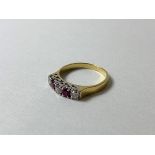 A diamond and ruby ring marked 18ct, size M, weighs 3.03 grammes