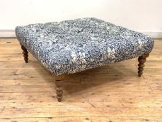 A Large contemporary footstool, the top upholstered in a deep buttoned linen fabric with blue