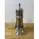 A 1963 Birmingham silver sugar castor with makers mark HCD, with flame finial, measures 18cm high,