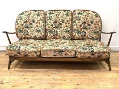 Ercol, A stained beech framed three seat sofa with upholstered squab cushions, H77cm, W175cm, D70cm