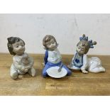 A group of three Nao figures of young children, tallest measures 10cm high