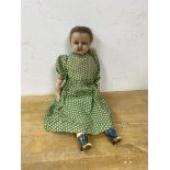 A Victorian doll, the head with wax exterior, ceramic arms and legs with painted boots, on stuffed