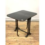 A Victorian ebonised Sutherland table, the top with drop leaves, canted corners and gilt detail on