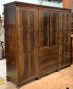 Whytock and Reid, An early 20th century mahogany combination triple wardrobe, the cavetto cornice