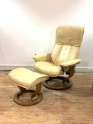 Ekornes Stressless, A reclining armchair and foot stool, upholstered in tan leather, raised on a