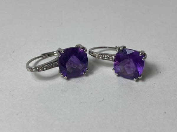 A pair of amethyst and diamond earrings, the cushion cut amethysts in mounts marked 14k