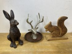 A painted cast metal stag's head mounted on dish, measures 21cm high, a composition hare and a