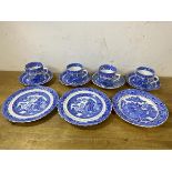 A set of four willow pattern teacups with saucers, and three side plates - measure 18cm diameter