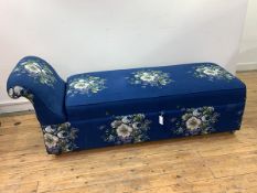 A mid 20th century chaise ottoman, upholstered in blue floral fabric, with hinged seat, raised on