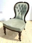 A Victorian mahogany framed slipper chair, the scrolled show frame enclosing deep buttoned