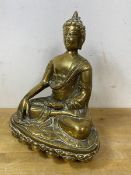 A South East Asian brass Buddha on lotus base stamped with crossed hand, measures 24cm high