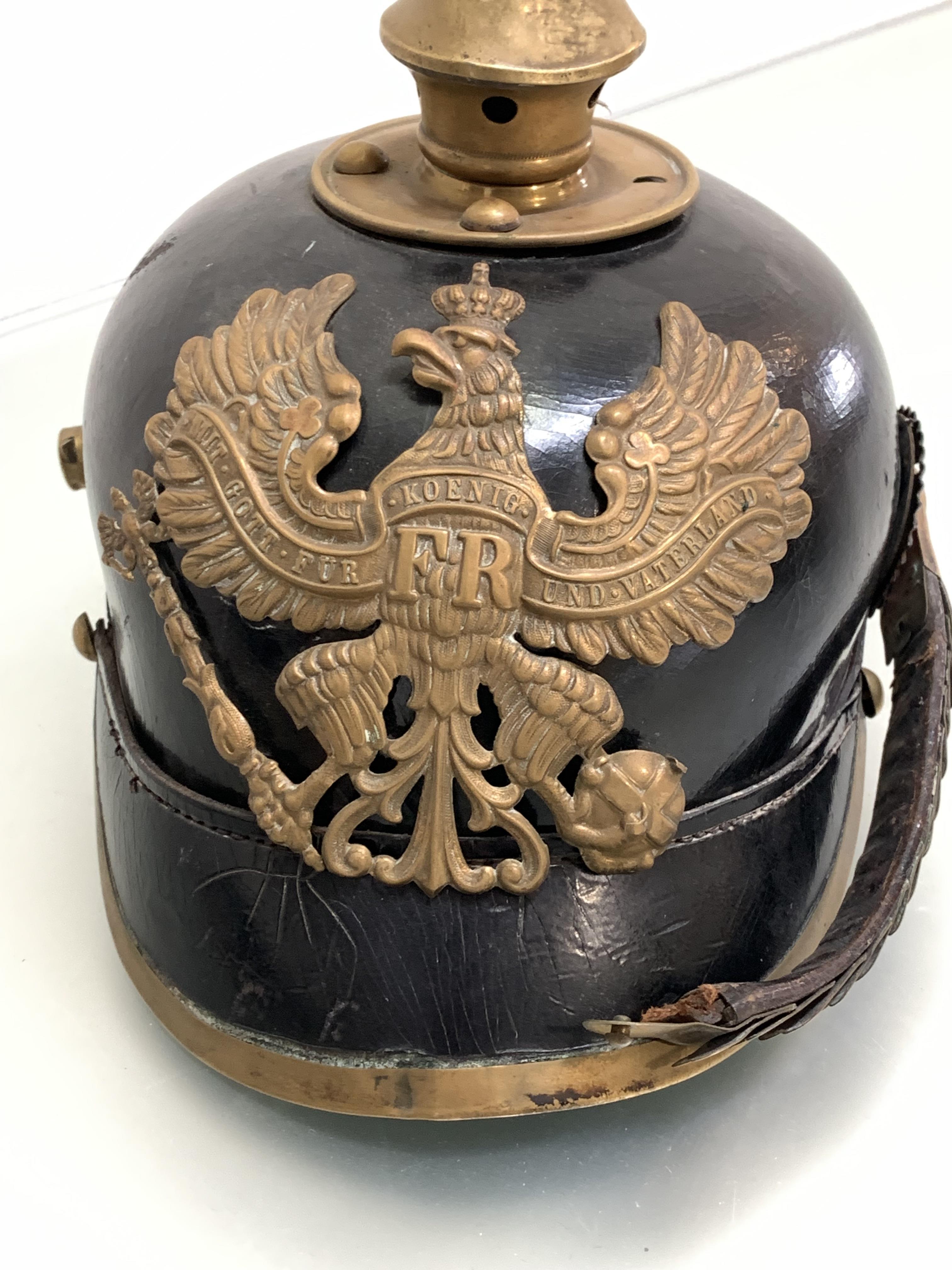 A WWI German Picklhaube black leather skull with brass fillings, one chinstrap and rosette