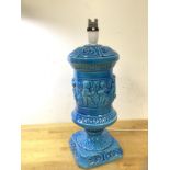 A Georgian inspired blue glazed table lamp of urn form with frieze depicting Putti, (41cm to top