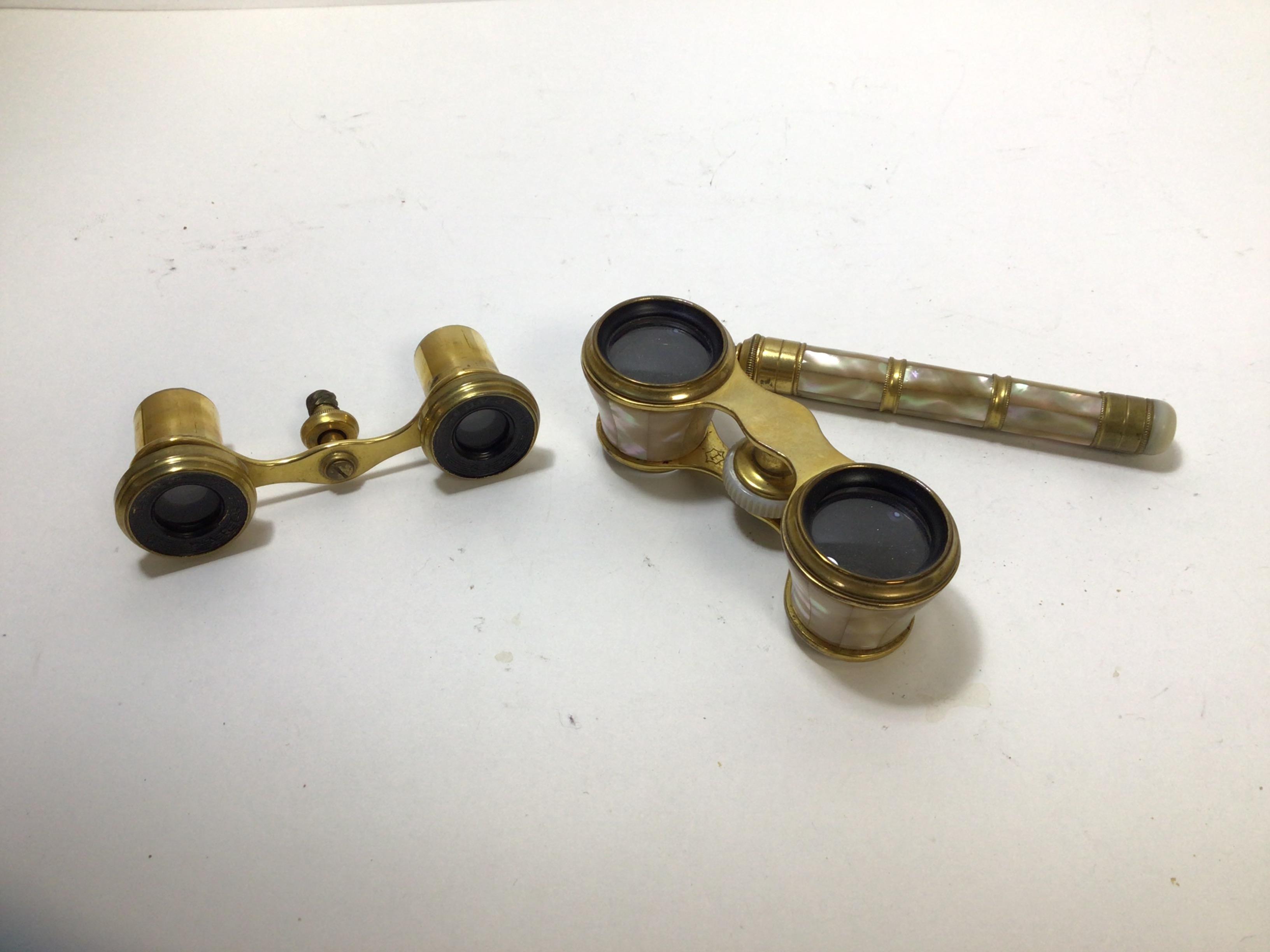 A pair of opera glasses with mother of pearl handle and eye pieces a/f, bridge marked with an I