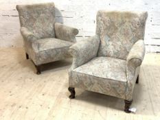 A pair of 1920s/1930s upholstered scroll back easy chairs, each raised on cabriole front supports,