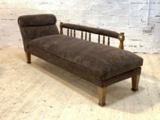 An Edwardian oak framed metamorphic chaise longue, the open arm rest on spindle gallery and seat