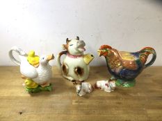 A group of three novelty china teapots including a Paul Cardew mother and ducklings doing fine, on