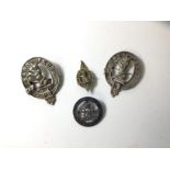 Three cast white metal moto brooches inscribed Sands Peur, a badge with G R I Sypher, inscribed