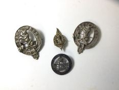 Three cast white metal moto brooches inscribed Sands Peur, a badge with G R I Sypher, inscribed