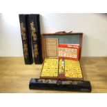 A Mah Jong set in original box, three laquered Mah Jong trays all with dragon and flaming pearl
