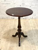 A 19th century mahogany tripod table, the circular top over turned column and triple splay supports,