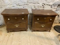 A pair of oak bedside tables, with serpentine fronts over two drawers, raised on cabriole