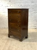 An Edwardian mahogany tall chest, the moulded top over six drawers, raised on bracket supports,